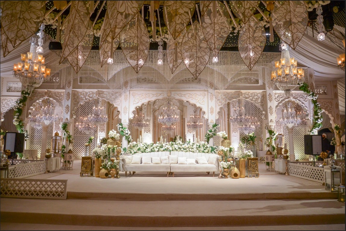 Walima decor in Lahore by VenueHub with white floral stage and chandeliers